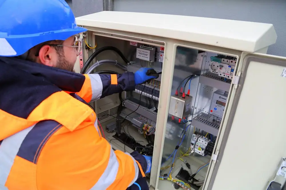 Electrician working at a breaker panel